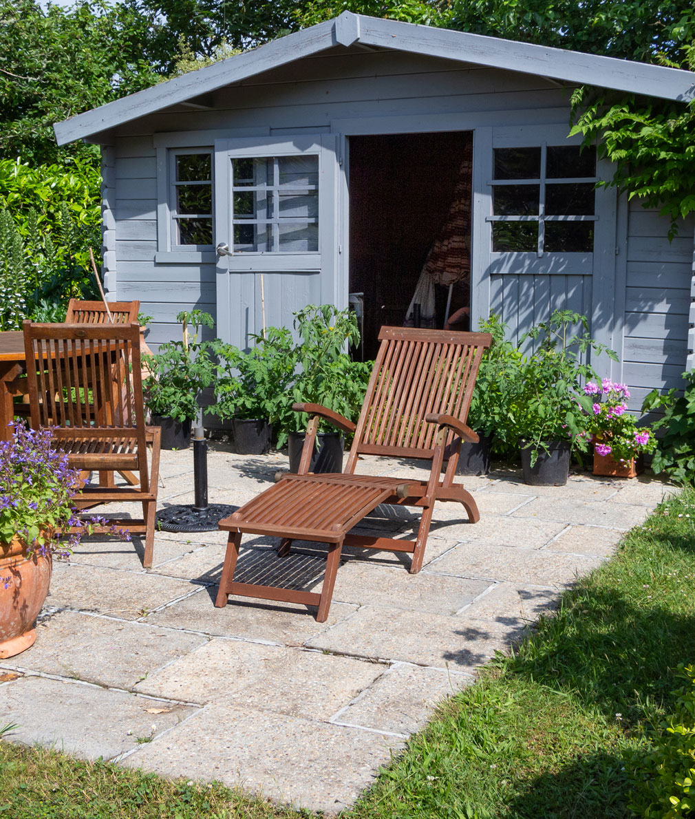 Quaint outdoor living area in front of shed