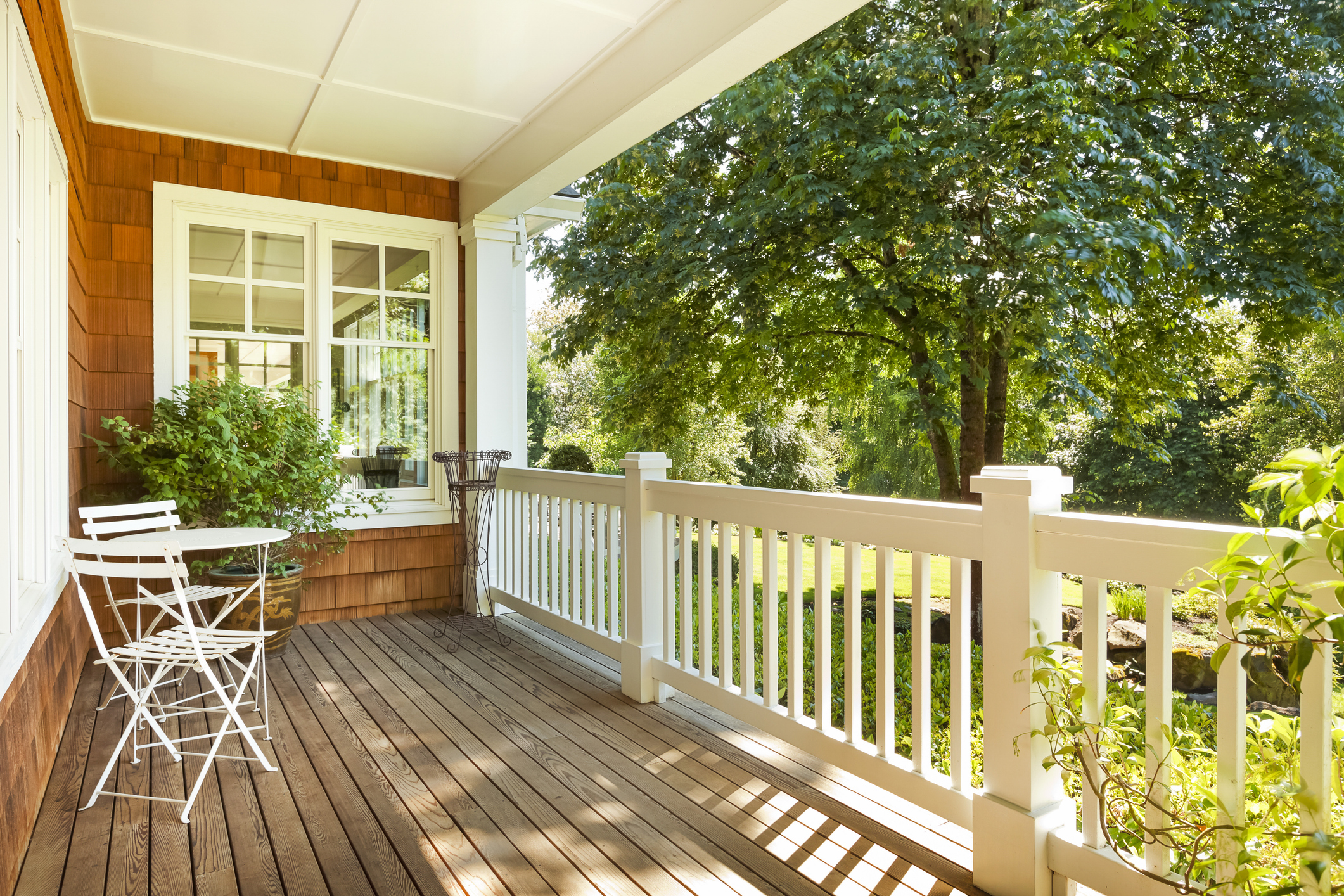 Beautiful front porch with table and chairs, on a lovely summer day